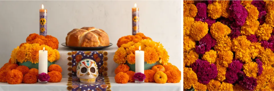 Traditional Day of the Dead altar with candles, sugar skulls, and marigold flowers.